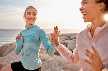 Image showing High five, spiritual and friends doing a meditation at the beach for health, mind and zen in Bali. Teamwork, laughing and women with hands for connection during an exercise for peace by the sea