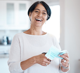 Image showing Senior woman, portrait and covid face mask with a scissor in hands for cutting while happy about freedom. Face of old person in house with smile for change, vaccine and corona recovery in retirement