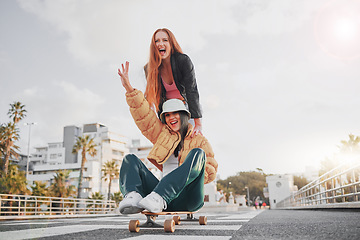 Image showing Fun, energy and portrait of friends on a skateboard for the weekend, bonding and playing in the city. Excited, silly and crazy women skateboarding for funny activity, happiness and playful in Sweden