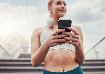 Image showing City, fitness and woman with smartphone, communication and smile typing after exercise low angle. Health, workout and personal trainer on phone, conversation and connect or network in sports training