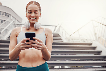 Image showing City, workout and woman with smartphone, smile for communication, typing and headphones after exercise. Health, training and runner on 5g phone, fitness app to connect or network in sports.