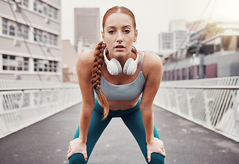 Image showing Sports, exercise and portrait of woman in city with motivation, determination and focus for health goals. Running, fitness and face of girl in urban town for workout, wellness and marathon training