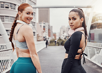 Image showing Portrait, fitness or friends on a bridge for training, cardio workout or exercise together in an urban city. Girl runners, partnership or healthy sports women ready to start running for body goals