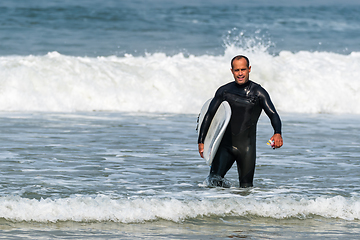 Image showing Surfer with board under his arm