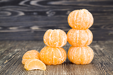 Image showing peeled whole and divided tangerines