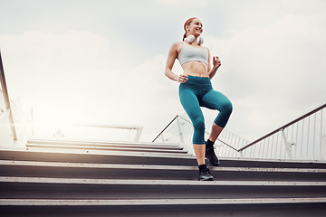 Image showing Fitness, woman and runner on stairs in the city for cardio exercise, training or healthy workout. Active female running and exercising on staircase for intense run or weight loss in an urban town