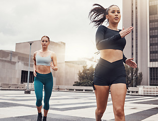 Image showing Women, running in city and fitness, runner outdoor for cardio and exercise friends race in Cape Town for active lifestyle. Sports, health and body training, run on urban rooftop with healthy people