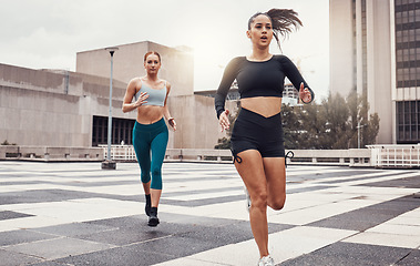 Image showing Women, running and fitness in city with cardio, exercise friends and active lifestyle together in Cape Town. Sports, health and body training, runner run race on urban rooftop with healthy people