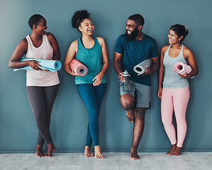 Image showing Yoga, fitness friends and wall of pilates class in a gym with a exercise and training break. Talking, wellness black people and communication of group on a floor ready for zen, balance and relax