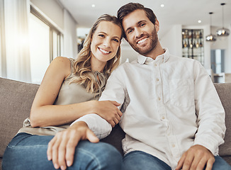 Image showing Couple. portrait and home of young people together on a living room couch with love and care. Happiness, smile and hug of a man and woman on a sofa feeling relax in a house lounge with marriage