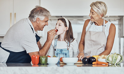 Image showing Love, grandparents or girl cooking or eating as a happy family in house kitchen with organic vegetables for dinner. Grandmother, old man or young child bonding or helping with healthy vegan food diet