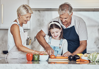 Image showing Learning, grandparents or girl cooking as a happy family in a house kitchen with organic vegetables for dinner. Grandmother, old man and child helping or cutting carrots for a healthy vegan food diet