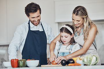 Image showing Learning, parents or girl cooking vegetables as a happy family in a house kitchen with organic food for dinner. Development, father or mother teaching, helping or cutting tomato with a healthy child