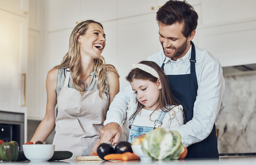 Image showing Learning, happy family or girl cooking or cutting vegetables in a kitchen with healthy food for dinner. Development, father or funny mother laughing, teaching or helping a kid or child in a meal