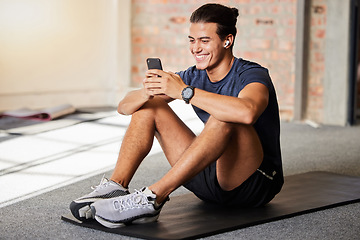 Image showing Bodybuilder, gym floor and texting with smile on chat app, social media or meme on internet for happiness. Man, fitness and exercise for health, wellness or relax at training for online communication