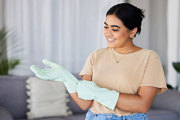 Image showing Cleaning, woman and gloves on hands in home for housekeeping, maintenance and safety. Happy cleaner, housewife and smile in apartment while ready for domestic chores, services and dirt free lifestyle