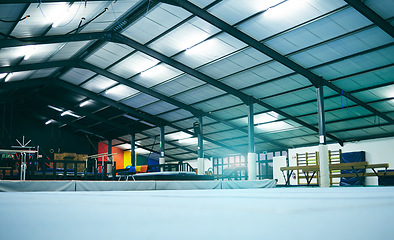 Image showing Interior hall of empty gymnastics arena, building and floor for training, professional performance or class. Backgrounds, studio space and room for olympic sports, workout or indoor athletic practice