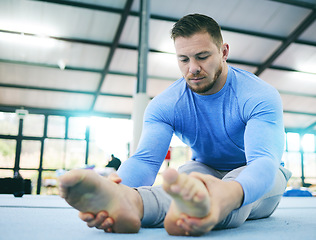 Image showing Gymnastics, exercise or man stretching legs in gym before training, workout or health wellness. Focus, serious fitness or sport athlete doing pilates, meditation or zen balance in sports studio floor