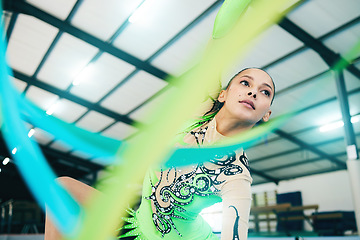 Image showing Gymnastics, ribbon dancer and woman doing a sport, fitness and dance performance in a gym. Moving, competition and exercise of a young female busy with training and dancing workout in a arena