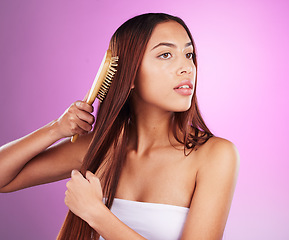 Image showing Hair care, brush and woman in studio for beauty cosmetics, skincare and salon color. Young model comb long hairstyle, textures and aesthetics for healthy shine, growth shampoo and body maintenance