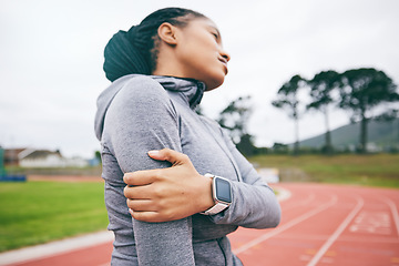 Image showing Black woman, arm pain and injury after exercise, workout or training accident at stadium. Winter sports, fitness and female athlete with fibromyalgia, inflammation or painful muscles after running