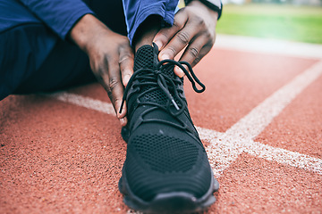 Image showing Sports, feet and man with ankle pain from exercise, workout and marathon training in stadium. Fitness, runner and shoes of athlete with joint strain, injury and arthritis from running on field track