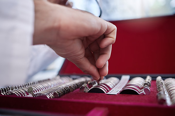 Image showing Optometry, test lens kit and hand of a optometrist preparing for a eye exam in a optical health clinic. Vision, diopter glasses and eyecare doctor or oculist fixing prescription lenses in optic store