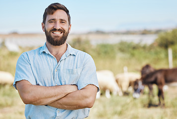 Image showing Farmer, portrait or arms crossed on livestock agriculture, sustainability environment or nature for farming industry. Smile, happy or confident man with animals growth or sheep and person on a field