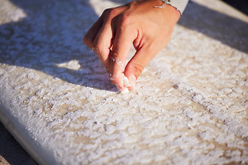 Image showing Hand, surfboard and wax with a sports man outdoor at the beach for surfing or recreation during summer. Fitness, surf and maintenance with a male surfer or athlete outside on the coast for surfing