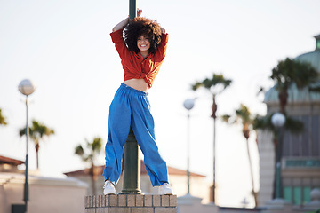 Image showing Fashion, streetwear and black woman in city with energy, excited and freedom of gen z youth or urban dancer. Natural hair, afro and young person or model in trendy clothes for outdoor hip hop style