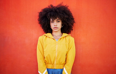 Image showing Portrait of woman with natural hairstyle on red background, model with afro and red copy space. Confident young person with serious expression, curly hair and aesthetic fashion on studio wall