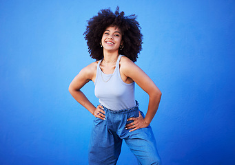 Image showing Fashion, natural hair and black woman isolated on a blue background for gen z, youth or cool portrait with mockup. Afro person or beautiful model with style, confidence and happy in studio space