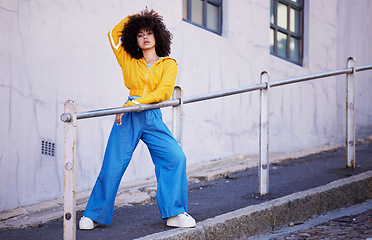 Image showing Black woman, urban fashion and beauty with portrait in city in street style, travel and natural hair, trendy and edgy. Streetwear, stylish and person posing in cityscape with designer brand clothes