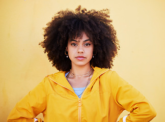 Image showing Portrait, fashion and attitude with an afro black woman in studio on a yellow background for style. Trendy, hair and serious with an attractive young female posing alone on product placement space