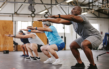 Image showing People, fitness and stretching in class at gym for workout, squat exercise or training together. Diverse group or team in warm up stretch session for sports, health and cardio wellness at gymnasium