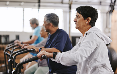 Image showing Senior workout group, exercise bike and cycling for fitness, health and retirement wellness by blurred background. Elderly teamwork, bicycle training and diversity with solidarity, focus and goals