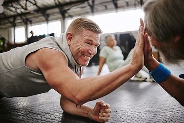 Image showing Exercise, old men on floor and high five for achievement, fitness goals or happiness in gym. Mature male athletes, senior citizens or gesture for celebration, workout target or on ground for training