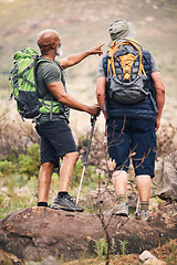 Image showing Nature, pointing and senior men hiking on mountain together for an outdoor backpack adventure. Freedom, fitness and elderly male friends bird watching and searching in the environment while trekking.