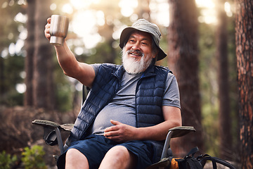 Image showing Camping, old man and in forest with coffee, smile and fresh air with break, vacation and relax. Camper, mature male and elderly guy with mug, tea and in woods for hobby, happiness and active citizen