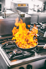 Image showing Chef is making flambe sauce