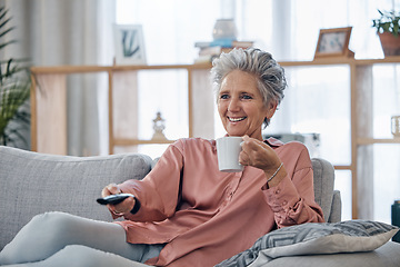 Image showing Senior woman, sofa and coffee to relax with remote for television, video or movies with smile in house. Elderly lady, couch and tea with happiness in home living room for watching tv in retirement