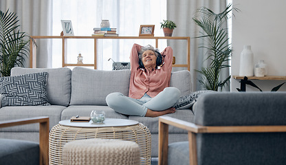 Image showing Retirement, old woman and sofa with headphones, relax and calm in living room, streaming music and audio. Female senior citizen, happy mature lady and headset for podcast, radio and carefree on couch