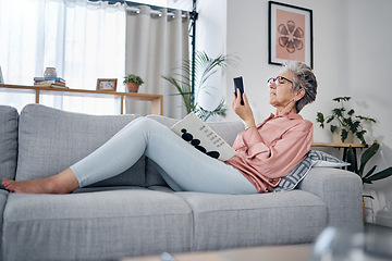 Image showing Elderly woman check phone, communication and relax at home, social media with technology and reading book. .Retirement, internet and chat online with wifi, text message or email with news website