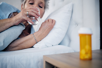 Image showing Sick, mature and woman drinking water with medicine for pain, virus or insomnia in bed. Healthcare, flu and elderly person in the bedroom for sleep with pills for an illness, infection or cold