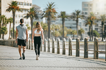 Image showing Fitness, teamwork or mockup with a runner couple on the promenade for cardio or endurance from the back. Exercise, wellness or workout with a man and woman athlete running outdoor in the city