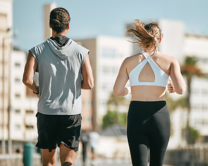 Image showing Couple, fitness and running back together in the city for exercise, workout or cardio routine in Cape Town. Active man and woman runner taking a walk or jog for healthy wellness or exercising outside