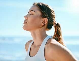 Image showing Face, breathing and sweating with an exercise woman outdoor in nature for a cardio or endurance workout. Fitness, breath or sweat and an attractive young female athlete standing with her eyes closed