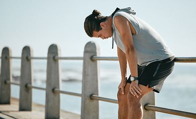 Image showing Tired, workout and breathing man for fitness training, cardio or outdoor running break at beach. Breathe, thinking and fatigue of athlete or sports person with exercise challenge in summer by ocean