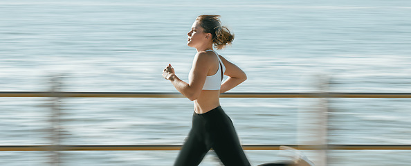 Image showing Woman, fitness and speed running by beach on mockup for exercise, workout or cardio routine. Active female runner in fast run, sprint or race by the ocean coast for healthy exercising or wellness