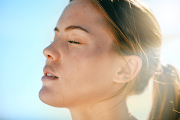 Image showing Face, breath and sweat with an exercise woman outdoor in nature for a cardio or endurance workout. Fitness, breathing or sweating and an attractive young female athlete standing with her eyes closed